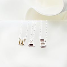 Elevate your everyday style with our Personalized Tiny Monogram Necklace! This initial charm necklace is the perfect way to show off your unique style and personality. Whether you choose your own initial or that of a loved one, this necklace is a beautiful way to add a personal touch to any outfit. Plus, it makes a wonderful gift for women who love simple, elegant jewelry. Please choose your letter at checkout. This necklace can be made of  one, two or three letters of your choice and one or two Minimalist Initials Sterling Silver Necklace, Minimalist Letter Necklaces For Everyday, Minimalist Silver Monogram Necklace, Silver Minimalist Initials Name Necklace, Minimalist Sterling Silver Initial Pendant Name Necklace, Silver Monogram Name Necklace In Minimalist Style, Minimalist Silver Initials Name Necklace, Silver Minimalist Monogram Name Necklace, Minimalist Silver Monogram Name Necklace