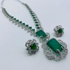 Bollywood Style Elegant Jewelry Sets For Formal Occasions, Traditional Green Bridal Sets For Formal Occasion, Silver Emerald Jewelry Sets With Elegant Design, Luxury Emerald Jewelry Sets Hand Set, Formal Emerald Necklace With Intricate Design, Luxury Hand Set Emerald Jewelry Sets, Formal Festive Emerald Jewelry Sets, Luxury Hand-set Emerald Jewelry Sets, Elegant Green American Diamond Jewelry Sets