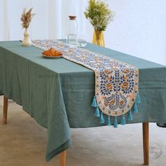 a blue table cloth with tassels on it