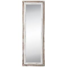 a tall mirror sitting on top of a white wall