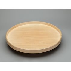 an empty wooden plate on a gray surface