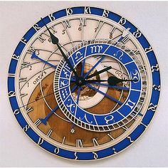 a blue and white clock with roman numerals in the middle on a wall