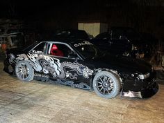 a black car with dragon designs painted on it