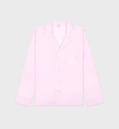 Made from 100% cotton poplin. Our Pyjama shirts are made in Portugal at one of the finest and oldest European shirt maker. Regular fit with a spread collar, straight hem and buttoned cuffs. - 100% Cotton- Mother of pearl buttons - Made in Portugal- 1 Chest pocket- Embroidered logo Cotton Spread Collar Tops For Loungewear, Pink Cotton Shirt With Placket, Long Sleeve Cotton Dress Shirt For Daywear, Cotton Long Sleeve Dress Shirt For Daywear, Cotton Shirt With Spread Collar For Loungewear, Cotton Shirt With Button Cuffs For Loungewear, Cotton Shirt With Lapel Collar And Buttons, Classic Shirt With Button Cuffs And Camp Collar, Classic Long Sleeve Shirt For Loungewear