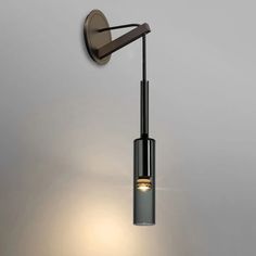 a wall light that is on the side of a wall with a lamp attached to it