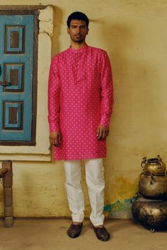 Rani pink woven straight kurta with contrasting bandhej prints and potli button detailed placket. Comes with solid contrasting white cotton silk pant. - Aza Fashions Pink Bandhgala With Chikankari Embroidery, Pink Straight Kurta Sherwani For Diwali, Pink Sherwani Straight Kurta For Diwali, Pink Straight Kurta Sherwani For Festivals, Traditional Pink Sherwani With Gota Work, Pink Straight Kurta For Festive Occasions, Diwali Pink Sherwani Straight Kurta, Pink Bandhgala With Chikankari Embroidery For Festivals, Pink Straight Sherwani For Diwali