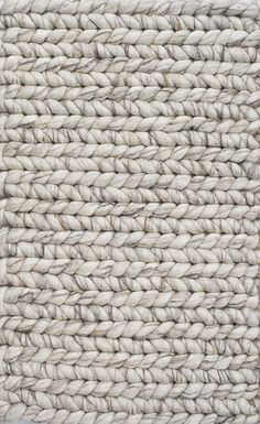 a close up view of the texture of an area rug with white and beige colors