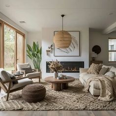 a living room with couches, chairs and a fire place in the middle of it