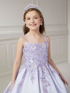 Your sweet girl will look unforgettable in this beaded floral applique long sleeveless dress with A-line mikado skirt by Tiffany Princess 13725. This sleeveless gown features a scoop neck spaghetti strap bodice with beaded floral lace appliques, A-line box pleated mikado skirt, side pockets, sweep train, and a lace-up back. House of Wu Tiffany Princess Collection Fall 2023 Style Number: 13725 Fabric: Beaded Lace Appliques/Mikado Colors: Blush Pink/Gold, Lilac, Navy Blue/Gold Sizes: 2, 4, 6, 8, 1 Long Sleeveless Dress, Girls Applique, Blush Gold, Sleeveless Gown, Princess Collection, Sleeveless Long Dress, Blush And Gold, Fall 2023, Floral Applique