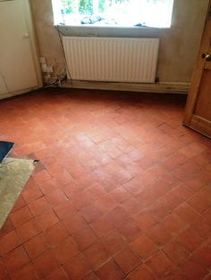 an empty room with a radiator in the corner