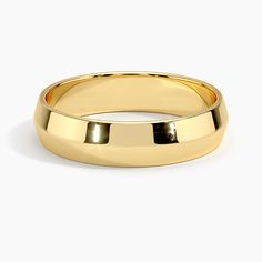 a gold wedding ring on a white background