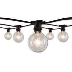 a string of light bulbs with black wire and clear glass globes on white background