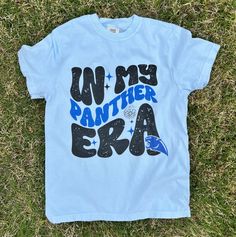 New product- In my Panther era Shirt! Get ready to show off your Panther pride with our Preppy Panthers Shirt, a must-have for all fans! Each shirt is printed by me using high-quality materials on a Comfort Colors shirt, known for its exceptional comfort and durability. Available in sizes S to 3X, we've got you covered regardless of your preferred fit. This design is an ideal choice for game days, tailgating parties, alumni events, or simply strolling around campus. This preppy Panther shirt is Panther School Shirt Designs, Cute Football Shirts Ideas, Panthers School Spirit Shirts, Cotton Slogan T-shirt For Fan Gear, Blue School Spirit T-shirt With Text Print, Slogan Tops For Fans, Blue School Spirit T-shirt With Heat Transfer Vinyl, School Spirit Graphic Print Shirt For Streetwear, Graphic Tee With Letter Print For Fans