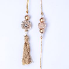 Express your love with this premium gold work bhaiya bhabhi rakhi set. A stunning set, it comprises of artistically designed rakhis with a gold-work pendant at the center. Gold and white beads adorn the 1-inch pendant on two sides, while a gold latkan adds to the beauty of the rakhi for bhabhi. Order this designer set today. Gold Temple Jewelry Tikka As Gift, Elegant Zari Work Jewelry For Puja, Intricate Design Tikka For Diwali Gift, Festive Rose Gold Jewelry For Celebration, Festive Celebration Rose Gold Jewelry, Gold Tikka For Navratri Gift, Zari Work Jewelry For Eid Puja, Eid Jewelry With Zari Work For Puja, Zari Work Jewelry For Puja And Eid