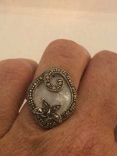 Vintage hand made about an in long Mother of Pearl set in 925 Sterling Silver Marcasite ring I have size 5.5 Can be re sized for you, my jeweler would charge $10 All rings are shipped in a nice gift box. Check out our over a THOUSAND great reviews Engraving is $4 per letter and is not always perfect depending on the piece. It can take a few days if the jeweler is busy. This is payable to Paypal Judithsltd@gmail.com Elegant Unique Opal Ring Gift, One-of-a-kind White Ring As Gift, Elegant Nickel-free Opal Ring For Gift, Victorian Marcasite Jewelry As A Gift, Victorian Marcasite Jewelry For Gifts, Victorian Marcasite Jewelry Gift, Marcasite Ring For Anniversary, Antique Marcasite Round Jewelry, Antique White Opal Ring For Gift