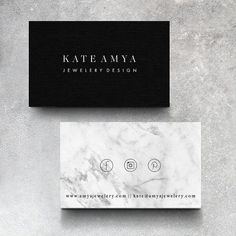 two business cards sitting next to each other on top of a marble surface with the name kate amaya jewelry design