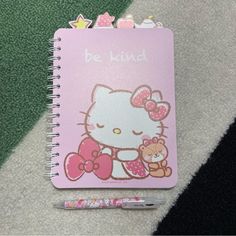 a hello kitty notebook with a teddy bear on it