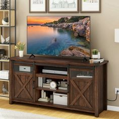 a flat screen tv sitting on top of a wooden entertainment center in a living room