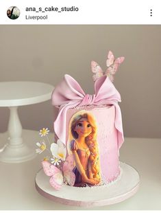 there is a cake decorated with a barbie doll on the top and butterflies around it