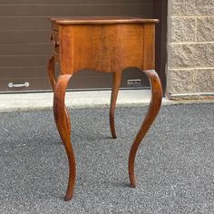 a small wooden table sitting in front of a garage door