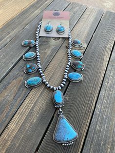 New without tags JEWELRY TYPE : Necklaces MAIN STONE : Turquoise TRIBAL AFFILIATION : Navajo METAL : Sterling Silver FEATURED REFINEMENTS : Navajo Pearls ARTISAN : Kathleen Chavez Absolutely STUNNING ! Royston Turquoise and Sterling Necklace is 20 inches long with a 3 inch drop and quite a beauty. Beautiful by itself or layered with your favorites. Matching Dangle Earrings are 1 3/4 inches long. Signed by the Talented Artist Kathleen Chavez & Stamped Sterling. Thank you for looking at our it Blue Teardrop Western Style Jewelry, Southwestern Style Teardrop Gemstone Jewelry, Southwestern Teardrop Gemstone Jewelry, Southwestern Style Turquoise Hand-strung Jewelry, Southwestern Teardrop Jewelry For Jewelry Making, One Of A Kind Southwestern Turquoise Jewelry, One-of-a-kind Southwestern Turquoise Jewelry, Untreated Blue Western Jewelry, Artisan Hand-strung Teardrop Jewelry