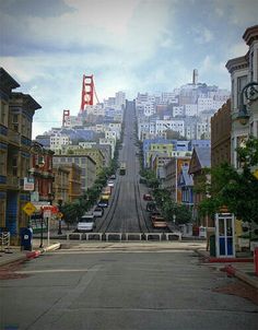 an empty street in the middle of a city with buildings on both sides and a golden gate at the top