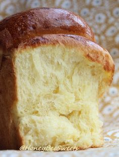 a close up of a loaf of bread on a table with a flowered cloth