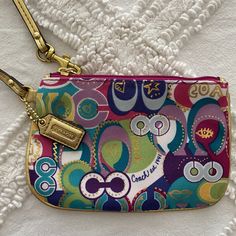 Poppy Pop Coach Wristlet - Never Used Before Gold Wristlet And Gold Hardware Throughout 4 Inches In Height And 6.5 Inches In Length No Signs Of Staining - Packaged In A Smoke Free Home Coach Multicolor Travel Wristlet, Coach Multicolor Wristlet For Travel, Multicolor Coach Wristlet For Travel, Multicolor Pouch Bag With Wrist Strap, Coach Multicolor Wristlet, Coach Multicolor Wristlet For Everyday, Multicolor Coach Wristlet For Daily Use, Multicolor Zipper Pouch Wristlet, Coach Multicolor Pouch Wristlet