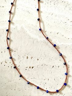 A delicate but strong silk thread with Lapis Lazuli natural gemstone crocheted into it. This necklace is designed for both casual and dress-up style. It is very light and comfortable to wear. Orangesh brown color silk cord Material: Lapis Lazuli Gemstone AAAA Quality (2.5X3.5mm), Silk cord, 14kgf (clasp), Bohemian Lapis Lazuli Beaded Necklace With Adjustable Fit, Adjustable Bohemian Lapis Lazuli Beaded Necklace, Adjustable Brown Hand Knotted Necklaces, Brown Adjustable Hand Knotted Necklace, Silk Cord Necklace, Lapis Lazuli Gemstone, Hippie Necklace, Silk Cord, Vintage Button