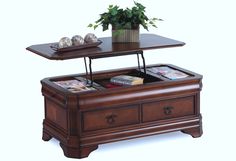 a coffee table with two trays on it and a plant in the middle,