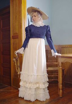 This Regency ensemble consists of these 3 pieces: dress, jacket, and lace collar. Early 1800s romantic styled ivory cotton gown with high waist. Historic look with short puffed sleeves gathered to cotton bands. The long cotton skirt is attached to the fitted bodice and has alternating ruffles and lace at the hemline. Back zipper closure. The separate short Spencer jacket in twill has long sleeves with flared split cuffs revealing the ruffled lace. The ruffled lace collar completes the Regency lo Marie Antoinette Style Victorian Dress With Ruffles, Regency Victorian Dress With Ruffles In Cream, Regency Style Victorian Dress For Vintage Events, Cotton Victorian Dress With Fitted Bodice For Daywear, Victorian Cotton Dress With Historical Design, Regency Style Fitted Vintage Cotton Dress, Fitted Victorian Cotton Prairie Dress, Fitted Cotton Regency Vintage Dress, Regency Style White Victorian Dress With Attached Cancan