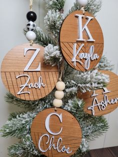 three wooden ornaments hanging from a christmas tree