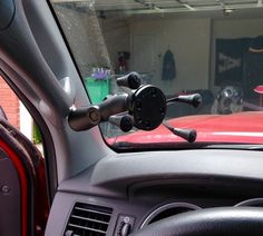 there is a steering wheel in the dashboard of a car that is parked next to a garage