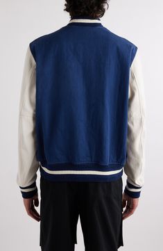 The house's founding is embroidered at the chest of this all-cotton varsity jacket featuring a herringbone weave on the sleeves for requisite contrast texture. 27 1/2" length (size 50EU) Front snap closure Band collar Front welt pockets Ribbed cuffs and hem 100% cotton Dry clean Made in Italy Designer Clothing Blue Cotton Varsity Jacket For Streetwear, White Cotton Varsity Jacket With Baseball Collar, White Cotton Track Jacket With Baseball Collar, White Collegiate Cotton Varsity Jacket, White Cotton Varsity Jacket, White Cotton Varsity Jacket In College Style, White Cotton College Style Varsity Jacket, Blue Cotton Varsity Jacket With Baseball Collar, Blue Cotton Outerwear With Baseball Collar