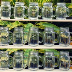 glass coffee mugs with names on them are displayed for sale in a store shelf