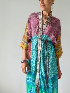 "This is mid length patchwork robe, with long puff sleeve super comfy wrap tie free size house colorful duster Made of vintage lightweight silk materials with different patterns Always one of a kind, perfect on your holiday at the beach or as a house  cover up  Easy to wear and flowy MEASURE Shoulder up to 23\" Bust up to 42\" Waist up to 42\" Length 40\" MATERIAL *up-cycled vintage silk For more boho style ideas please visit also  https://www.etsy.com/uk/shop/Gyaki CARE INSTRUCTIONS  Wash separ Multicolor Patchwork Kimono For Spring, Multicolor Long Kimono For Loungewear, Bohemian Multicolor Robe For Spring, Multicolor Bohemian Robe For Spring, Green Patchwork Kimono For Spring, Long Sleeve Multicolor Robe For Summer, Long Sleeve Patchwork Kaftan For Summer, Summer Long Sleeve Kaftan With Patchwork, Bohemian Long Sleeve Kaftan With Patchwork