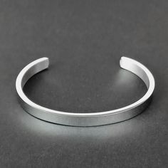 Embrace the Viking tradition of adornment with our Men's Silver Cuff Bracelet, a classic yet modern representation of Norse metalwork. Crafted from high-quality stainless steel, this bangle reflects the Viking passion for decoration in every aspect of life. Its sleek polished finish offers a contemporary twist to traditional Viking aesthetics, making it a perfect accessory for those who value both history and modern style. - Material: Stainless Steel - Rust, scratch and tarnish resistant; hypoal Classic Metal Bangle With Polished Finish, Classic Silver Stainless Steel Bracelets, Formal Stainless Steel Cuff Bracelet With Polished Finish, Formal Stainless Steel Bangle With Polished Finish, Classic Metal Cuff Bracelet, Classic Metal Cuff Bracelets, Silver Stainless Steel Bangle With Polished Finish, Minimalist Bangle With Stainless Steel Clasp, Classic Silver Metal Bangle