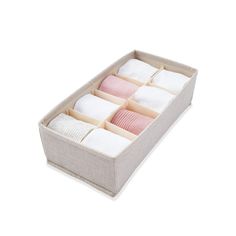 an open drawer with several folded towels in it on a white background and the lid is closed