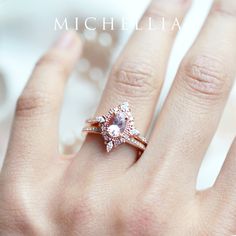 a woman's hand with a pink diamond ring on top of her left hand