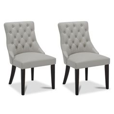 a pair of chairs with buttons on the back and legs, both in grey leather