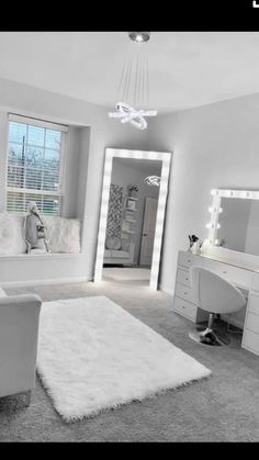 a bedroom with white furniture and large mirrors on the wall, along with an area rug that looks like sheepskin