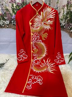 a red chinese dress with gold dragon embroidered on it