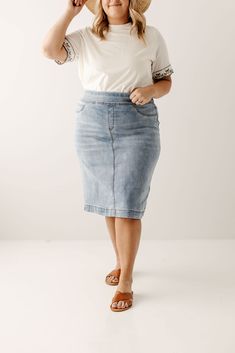 Simple lines, classic and comfortable, the 'Sara' is everything a denim skirt should be! This skirt is made from a soft, stretch denim to ensure a flattering and modest fit and is as comfy as they come! The details include minimal distressing, faux front pockets, and functional back pockets. Featuring a wide waistband for extra comfort and ease of styling. Exclusively designed by us for you. 97% Cotton 3% Spandex Machine Wash Cold Hang to Dry Functional Back Pockets Available in 21", 24", and 26 French Capsule Wardrobe, Denim Skirts Knee Length, Corduroy Overall Dress, Clothing Wishlist, Denim Skirt Outfits, Modest Fits, Mama Style, Overall Dress, Light Wash Denim