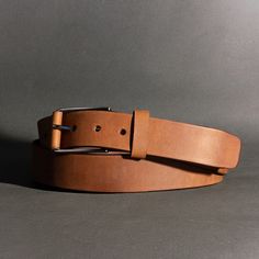 Inspired by the resilience and rugged durability of the spartans, this belt is made from 9-10oz distressed leather. This beautiful leather is aniline dyed in a drum giving it unique and vibrant colors. When the leather is stretched or pulled, the color gets lighter in the pulled areas (also called pull-up leather). Just as a Spartan wears his scars proudly, this belt will show color changes, unique marks, and a rich patina (shine) over time, ensuring that no two pieces are identical. The unique Tan Leather Belt, Leather And Brass, The Alchemist, Raw Leather, Brown Leather Belt, Secret Ingredient, Distressed Leather, Pull Up, Leather Wraps