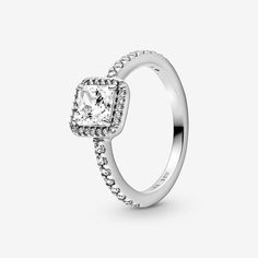 an engagement ring with a square cut diamond in the center and pave - set shoulders