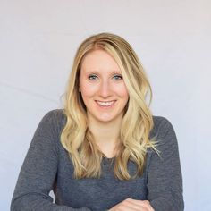 a woman sitting at a table with her arms crossed