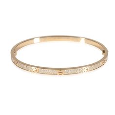 Cartier Love Bracelet, Small Model, Paved (Yellow Gold)  PRIMARY DETAILS  SKU: 141107  Listing Title: Cartier Love Bracelet, Small Model, Paved (Yellow Gold)  Condition Description: Cartier's Love collection is the epitome of iconic, from the recognizable designs to the history behind the line-up. The collection started in 1969 with the bangle bracelet, which is engraved with a circular motif throughout to mimic the look of the bracelet's signature screw-lock mechanism.     In excellent condition and recently polished. Comes with the original box and papers.  Brand: Cartier  Collection/Series: Love  Metal Type: Yellow Gold  Metal Purity: 18k  Chain or Bracelet Length (in): 17  Pre-Owned Jewelry Condition: Excellent  SIDE STONE INFORMATION  Side Stone Weight 1 (cts): 0.95  Side Stone 1 Shap Rose Gold Diamond Bangle With Pave Setting, Diamond Bangle In Rose Gold With Pave Setting, Cartier Fine Jewelry Bracelet With Diamond Accents, Cartier Bangle With Single Cut Diamonds, Cartier Diamond Accented Bracelets As Gift, Cartier Bracelets With Diamond Accents For Gift, Rose Gold Bangle With Pave Setting, Cartier Bangle Bracelets With Diamond Accents, Cartier Wedding Diamond Bracelet With Vvs Clarity