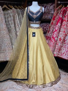 Bright gold plain skirt with black foiled work waist border paired with contrasting black kundan, stone and zardozi embroidery blouse and butti net dupatta. Fabric: Raw Silk This outfit can be customized in multiple colors and specific to client measurements. 90 days of production time is required and are for bulk orders only! Orders are processed in store only! Final fittings/alterations not included. Minimum Order Quantity- 4 pieces Gold Chanderi Traditional Party Wear, Gold Embellished Raw Silk Anarkali Set, Gold Embellished Raw Silk Choli, Gold Embellished Chanderi Dress, Gold Raw Silk Traditional Party Wear, Gold Dola Silk Party Wear Dupatta, Gold Embellished Anarkali Party Wear Set, Gold Embellished Anarkali Set For Party, Gold Raw Silk Sharara For Party Wear