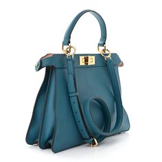 This is an authentic FENDI Calfskin Medium Peekaboo I SEE U Satchel in Blue Velvet and Light Rose. This stylish bag is crafted of soft calfskin leather in blue. The bag features a top handle and gold hardware including Fendi logo turn locks. When held by the top handle with the clasps open the interior details peek out. The top opens to a partitioned leather interior with a removable pouch. Fendi Logo, Light Rose, Rose Lights, Stylish Bag, Blue Velvet, Leather Interior, Interior Details, Gold Hardware, Top Handle