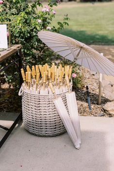 an umbrella and some wine bottles in a basket